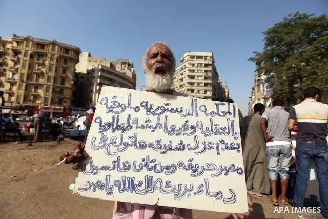 An Egyptian protester holds a placard against presidential candidate Ahmed Shafik during a protest at Cairo's Tahrir square, Egypt, 14 June 2012. Media reports on 14 June state that the Supreme Constitutional Court ruled...
