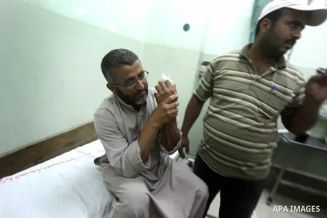 A Palestinian wounded man arrives to Naser hospital following an Israeli strike on June 14, 2012 in Khuza'a town , in the east of Khan Younis city in the south of gaza strip. Photo by Ashraf Amra