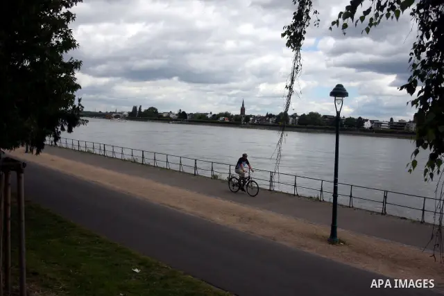 A German man rides a bicycle near the river Rhine near the city of Bonn in Germany on 15 June 2012. The Rhine is one of the longest and most important rivers in Europe. It runs for over 1,232 km .Rhine flows through six...