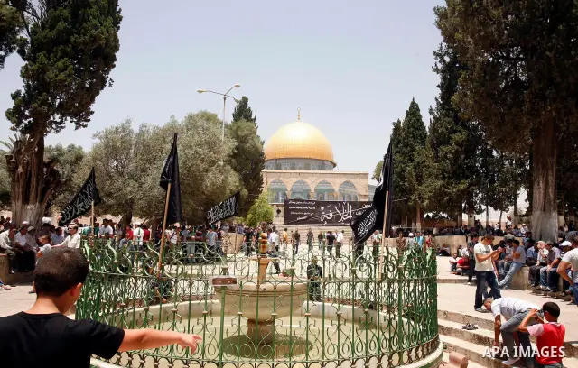 Dozens of members of the Islamic Liberation Movement, take part in a rally to mark anniversary of the overthrow of the Islamic Caliphate at Al-Aqsa Mosque following the friday prayers in the Jerusalem old city on 15 June...