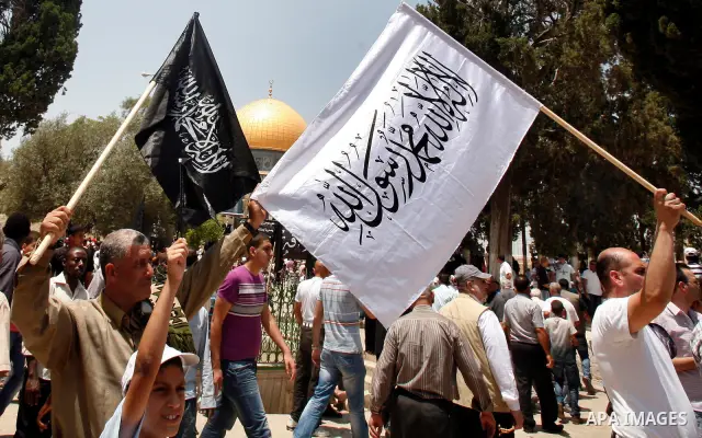 Dozens of members of the Islamic Liberation Movement, take part in a rally to mark anniversary of the overthrow of the Islamic Caliphate at Al-Aqsa Mosque following the friday prayers in the Jerusalem old city on 15 June...