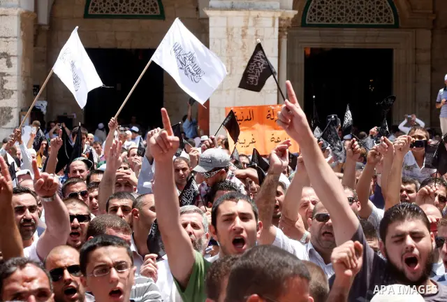 Dozens of members of the Islamic Liberation Movement, take part in a rally to mark anniversary of the overthrow of the Islamic Caliphate at Al-Aqsa Mosque following the friday prayers in the Jerusalem old city on 15 June...