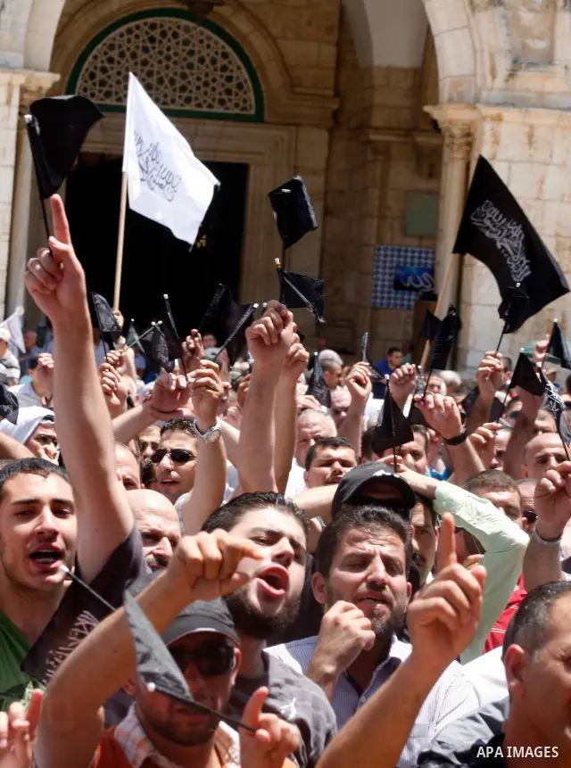 Dozens of members of the Islamic Liberation Movement, take part in a rally to mark anniversary of the overthrow of the Islamic Caliphate at Al-Aqsa Mosque following the friday prayers in the Jerusalem old city on 15 June...