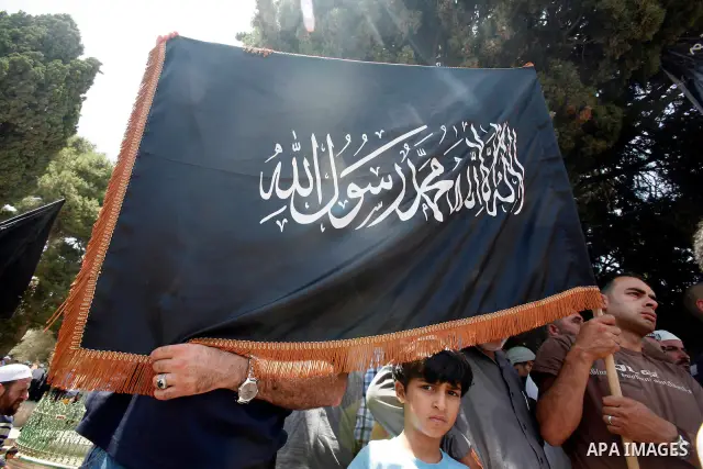 Dozens of members of the Islamic Liberation Movement, take part in a rally to mark anniversary of the overthrow of the Islamic Caliphate at Al-Aqsa Mosque following the friday prayers in the Jerusalem old city on 15 June...