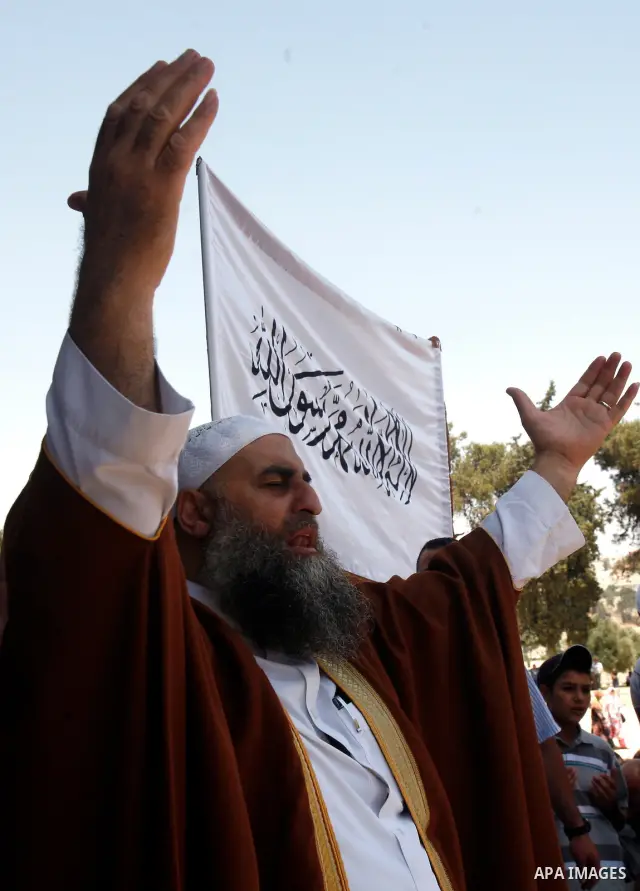 Dozens of members of the Islamic Liberation Movement, take part in a rally to mark anniversary of the overthrow of the Islamic Caliphate at Al-Aqsa Mosque following the friday prayers in the Jerusalem old city on 15 June...