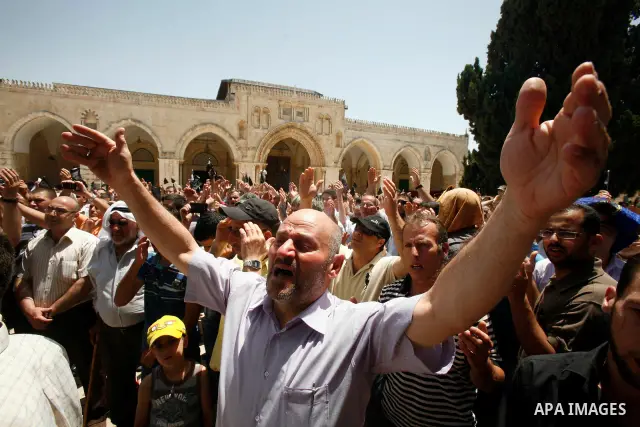 Dozens of members of the Islamic Liberation Movement, take part in a rally to mark anniversary of the overthrow of the Islamic Caliphate at Al-Aqsa Mosque following the friday prayers in the Jerusalem old city on 15 June...