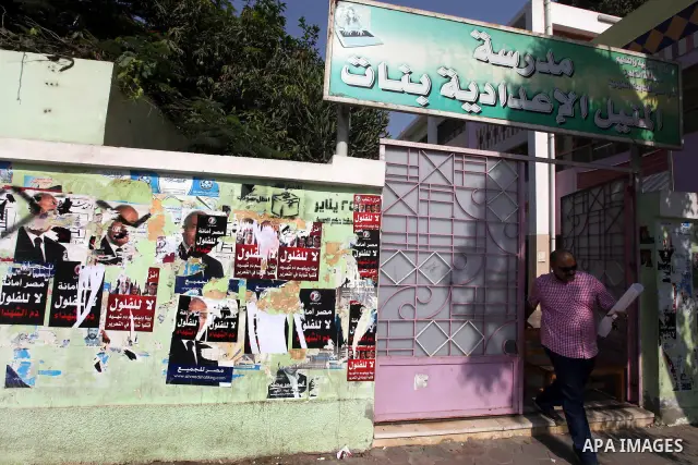 An Egyptian man stands in front of a polling station on June 15, 2012 on the eve of Egypt's second round of presidential runoff elections. Egypt's transition to democracy was thrown into further disarray after its top co...