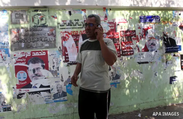An Egyptian man talks on mobile in front of a polling station on June 15, 2012 on the eve of Egypt's second round of presidential runoff elections. Egypt's transition to democracy was thrown into further disarray after i...