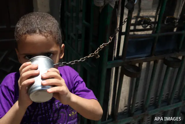 An Egyptian boy drinks water during voting at a polling station in Cairo on June 16, 2012 in a divisive presidential runoff pitting ousted strongman Hosni Mubarak's last premier Ahmed Shafiq against Muslim Brotherhood ca...