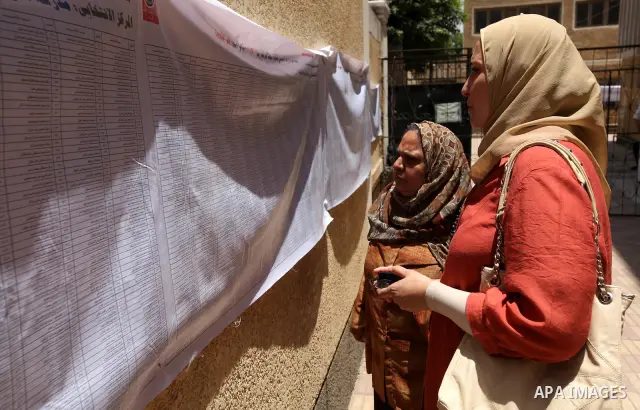 A voter checks her name at a polling station in Cairo June 16, 2012. Egypt's first free presidential election concludes this weekend in a run-off between the Muslim Brotherhood's candidate Mohamed Morsy and Ahmed Shafik,...