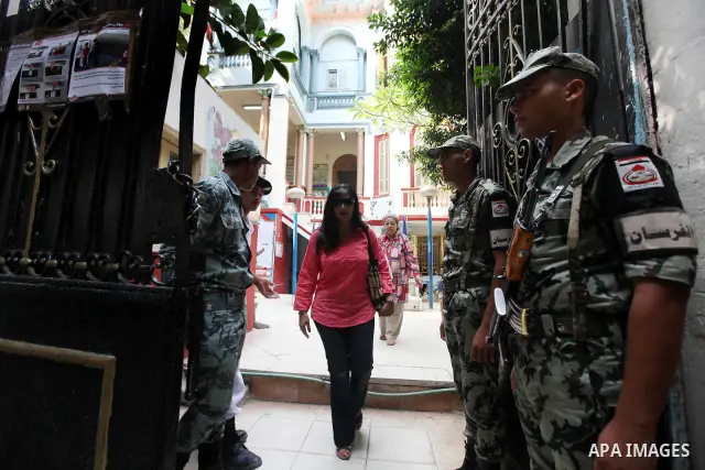 Egyptians solider stand guard outside a polling station in Cairo on June 17, 2012 in a divisive presidential runoff pitting ousted strongman Hosni Mubarak's last premier Ahmed Shafiq against Muslim Brotherhood candidate...