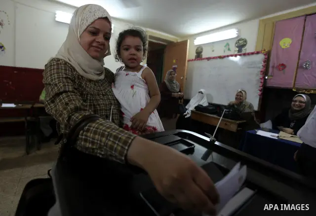 An Egyptian woman votes at a polling station in Cairo on June 17, 2012, as polling opened in Egypt's final day of a divisive election to choose a successor to ousted president Hosni Mubarak, in a race that pits a former...