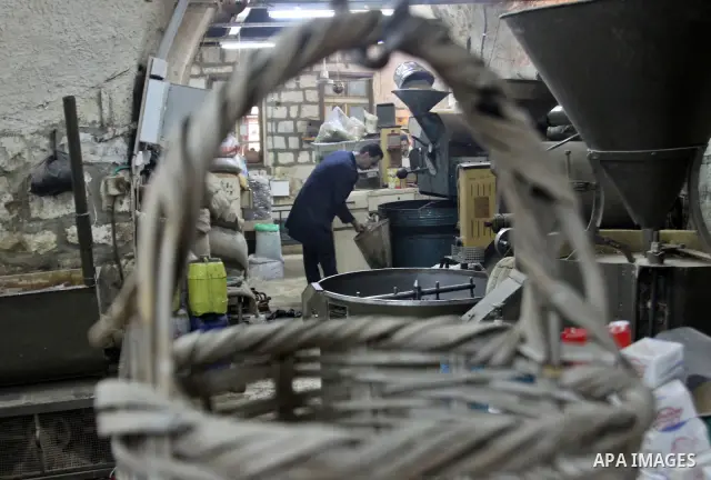 A Palestinian man makes coffe a factory in the West Bank city of Nablus on June 17, 2012. Nablus is famous of manufacturing several different types of spices. Photo by Nedal Eshtayah