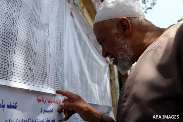 Voters check for their names before casting their votes during the second day of voting in Egypt's presidential election at a polling station in Cairo June 17, 2012. A second day of voting on Sunday will deliver Egypt's...