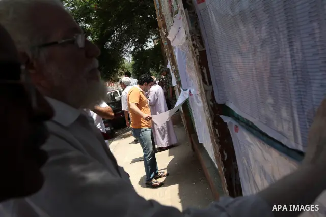 Voters check for their names before casting their votes during the second day of voting in Egypt's presidential election at a polling station in Cairo June 17, 2012. A second day of voting on Sunday will deliver Egypt's...