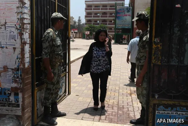 Egyptians solider stand guard outside a polling station in Cairo on June 17, 2012 in a divisive presidential runoff pitting ousted strongman Hosni Mubarak's last premier Ahmed Shafiq against Muslim Brotherhood candidate...