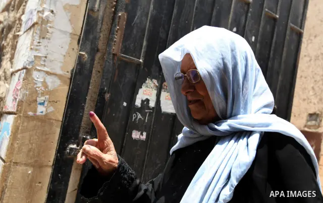 An Egyptian woman shows his ink-stained finger after voting at a polling station in Cairo on June 17, 2012 on Egypt's final day of a divisive election to choose a successor to ousted president Hosni Mubarak, in a race th...