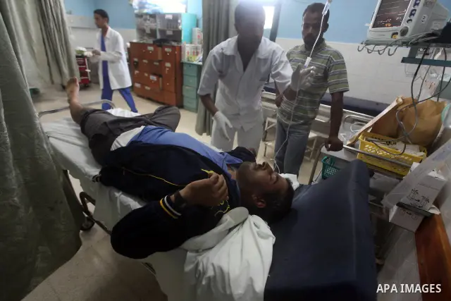 Palestinian medics treat a wounded Palestinian man at al Aqsa hospital in the central Gaza Strip town of Deir Al Balah, on 17 June 2012. Israeli forces opened fire after incursion Gaza east border about 300 meters. Photo...