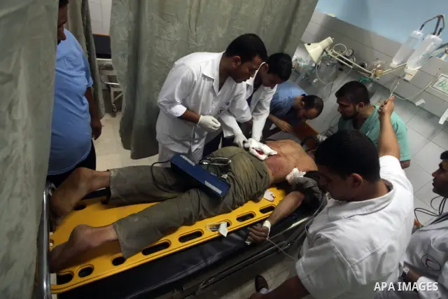 Palestinian medics treat a wounded Palestinian man at al Aqsa hospital in the central Gaza Strip town of Deir Al Balah, on 17 June 2012. Israeli forces opened fire after incursion Gaza east border about 300 meters. Photo...