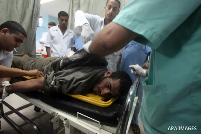 Palestinian medics treat a wounded Palestinian man at al Aqsa hospital in the central Gaza Strip town of Deir Al Balah, on 17 June 2012. Israeli forces opened fire after incursion Gaza east border about 300 meters. Photo...