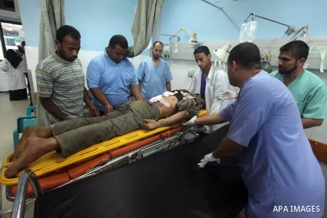 Palestinian medics treat a wounded Palestinian man at al Aqsa hospital in the central Gaza Strip town of Deir Al Balah, on 17 June 2012. Israeli forces opened fire after incursion Gaza east border about 300 meters. Photo...