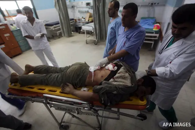 Palestinian medics treat a wounded Palestinian man at al Aqsa hospital in the central Gaza Strip town of Deir Al Balah, on 17 June 2012. Israeli forces opened fire after incursion Gaza east border about 300 meters. Photo...