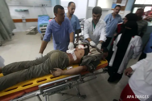 Palestinian medics treat a wounded Palestinian man at al Aqsa hospital in the central Gaza Strip town of Deir Al Balah, on 17 June 2012. Israeli forces opened fire after incursion Gaza east border about 300 meters. Photo...