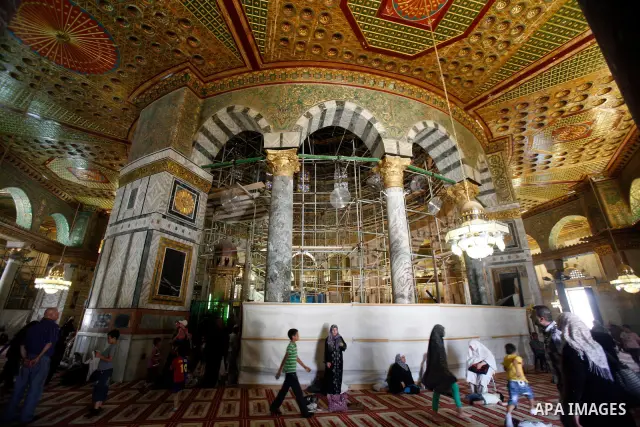 Palestinians take part in a celebration of the Islamic holiday of Isra Mi'raj in the Al-Aqsa mosque, in the Jerusalem old city, on June 17, 2012. The holiday marks what Muslims believe is Prophet Mohammad's journey from...