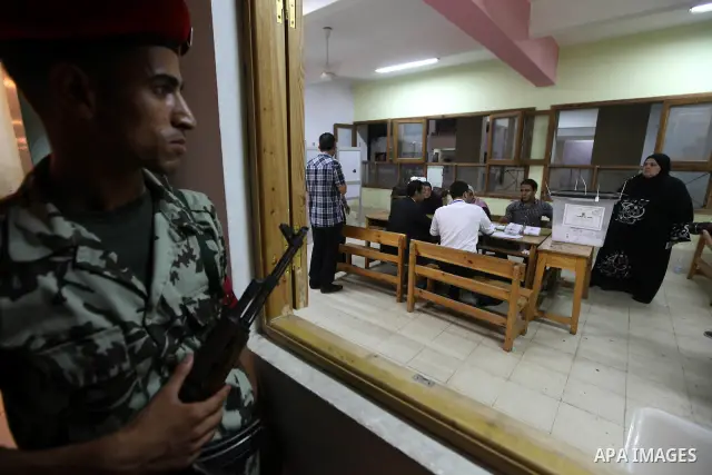 Egyptian soldiers stand alert as election officials count ballots at a polling center on the second day of the presidential runoff, in Cairo, Egypt, Sunday, June 17, 2012. Egyptians voted for a second day Sunday in a pre...