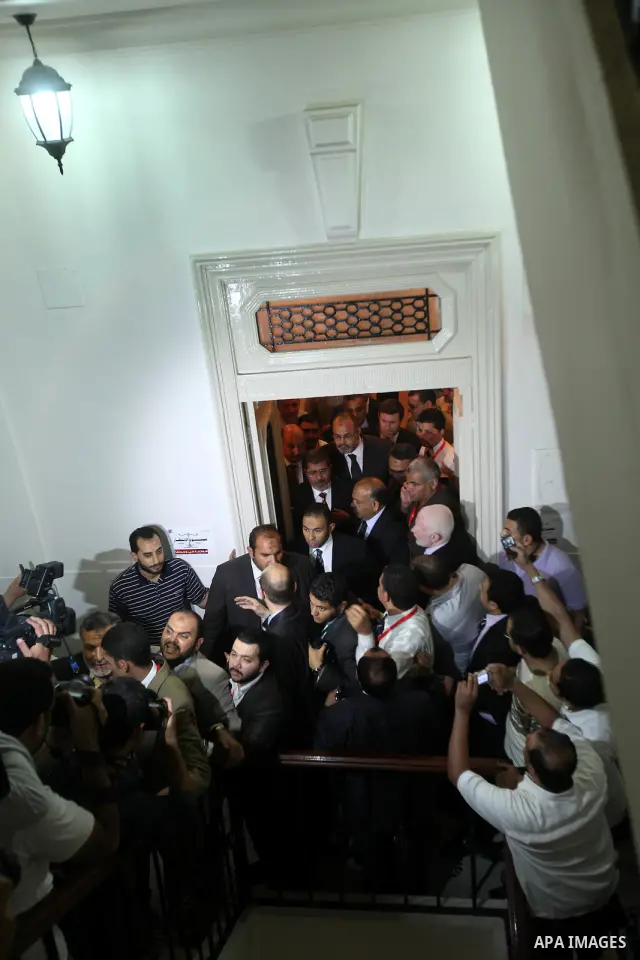 Egypt's Muslim Brotherhood candidate Mohammed Mursi waves amongst his supporters after the announcement of presidential election results at the electoral headquarters in Cairo on June 18, 2012. The campaign of Egyptian p...
