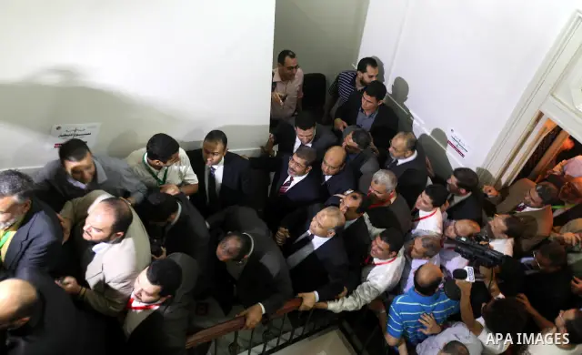 Egypt's Muslim Brotherhood candidate Mohammed Mursi waves amongst his supporters after the announcement of presidential election results at the electoral headquarters in Cairo on June 18, 2012. The campaign of Egyptian p...