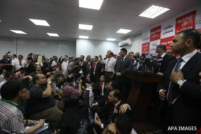 Egypt's Muslim Brotherhood candidate Mohammed Mursi waves amongst his supporters after the announcement of presidential election results at the electoral headquarters in Cairo on June 18, 2012. The campaign of Egyptian p...