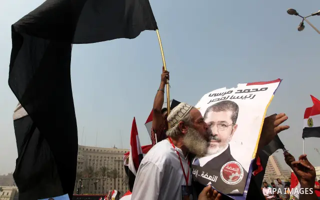 Supporters of presidential candidate Mohammed Morsi carry Egyptian and Muslim Brotherhood flags during celebrations claiming victory in Tahrir Square, Cairo, Egypt, Monday, June 18, 2012. The Muslim Brotherhood declared...
