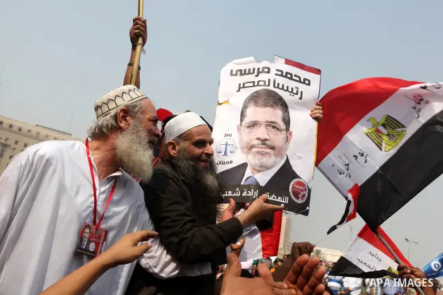 Supporters of presidential candidate Mohammed Morsi carry Egyptian and Muslim Brotherhood flags during celebrations claiming victory in Tahrir Square, Cairo, Egypt, Monday, June 18, 2012. The Muslim Brotherhood declared...