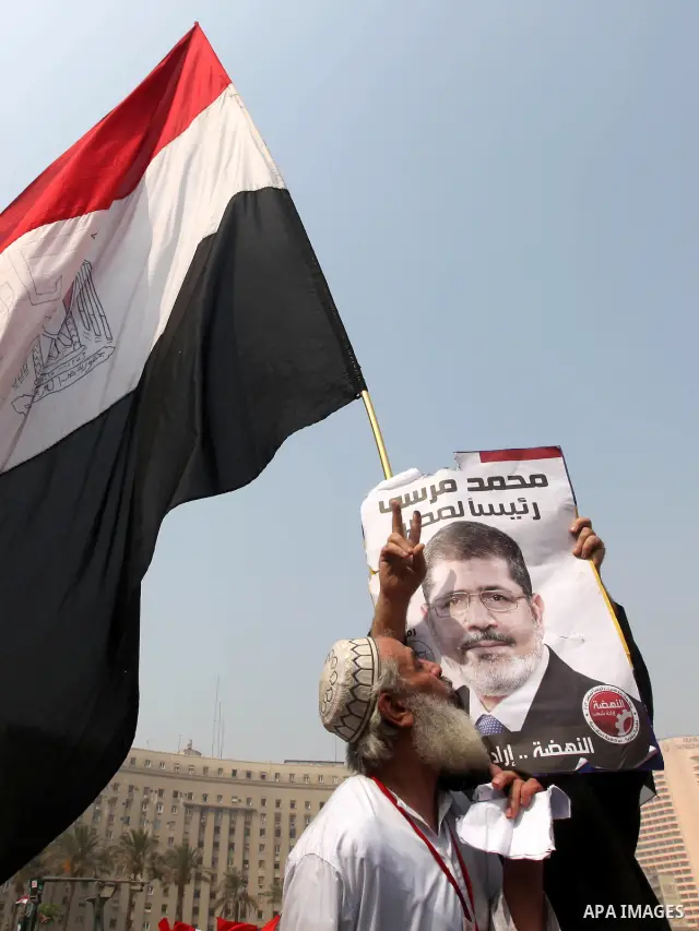 Supporters of presidential candidate Mohammed Morsi carry Egyptian and Muslim Brotherhood flags during celebrations claiming victory in Tahrir Square, Cairo, Egypt, Monday, June 18, 2012. The Muslim Brotherhood declared...
