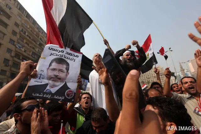 Supporters of presidential candidate Mohammed Morsi carry Egyptian and Muslim Brotherhood flags during celebrations claiming victory in Tahrir Square, Cairo, Egypt, Monday, June 18, 2012. The Muslim Brotherhood declared...