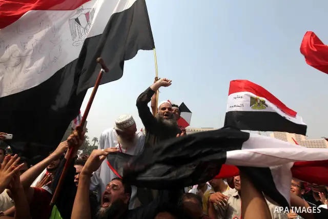 Supporters of presidential candidate Mohammed Morsi carry Egyptian and Muslim Brotherhood flags during celebrations claiming victory in Tahrir Square, Cairo, Egypt, Monday, June 18, 2012. The Muslim Brotherhood declared...