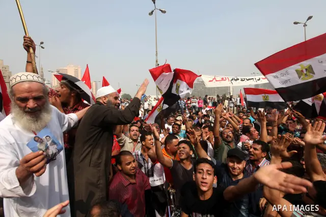Supporters of presidential candidate Mohammed Morsi carry Egyptian and Muslim Brotherhood flags during celebrations claiming victory in Tahrir Square, Cairo, Egypt, Monday, June 18, 2012. The Muslim Brotherhood declared...