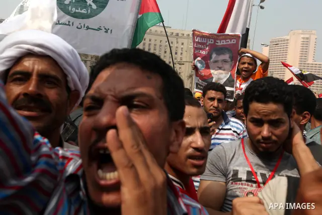Supporters of presidential candidate Mohammed Morsi carry Egyptian and Muslim Brotherhood flags during celebrations claiming victory in Tahrir Square, Cairo, Egypt, Monday, June 18, 2012. The Muslim Brotherhood declared...