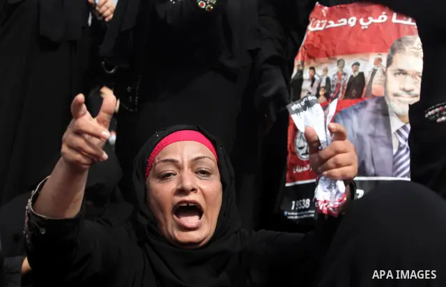 Supporters of presidential candidate Mohammed Morsi carry Egyptian and Muslim Brotherhood flags during celebrations claiming victory in Tahrir Square, Cairo, Egypt, Monday, June 18, 2012. The Muslim Brotherhood declared...