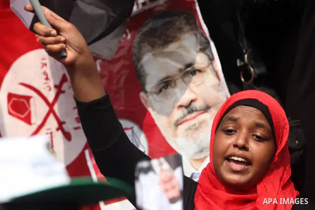 Supporters of presidential candidate Mohammed Morsi carry Egyptian and Muslim Brotherhood flags during celebrations claiming victory in Tahrir Square, Cairo, Egypt, Monday, June 18, 2012. The Muslim Brotherhood declared...
