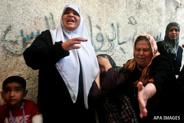 Relatives of Palestinian militant Ismail Odeh mourn during his funeral in Beit Hanun in the northern Gaza Strip on June 18, 2012. Odeh was one of two Palestinians killed in an Israeli strike on north Gaza in the morning,...