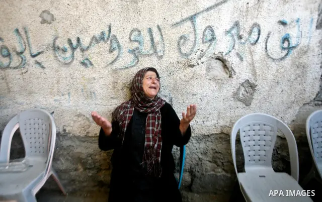 A relative of Palestinian militant Ismail Odeh mourns during his funeral in Beit Hanun in the northern Gaza Strip on June 18, 2012. Odeh was one of two Palestinians killed in an Israeli strike on north Gaza in the mornin...