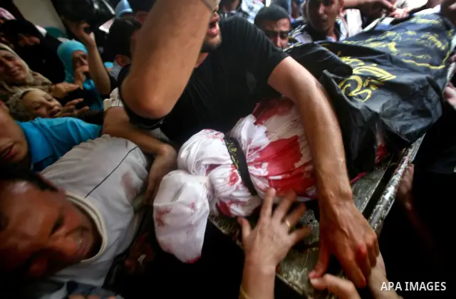 Palestinian mourners carry the body of one of the two Palestinians who were killed in an Israeli air strike on north Gaza during their funeral on June 18, 2012. Witnesses identified the two men as members of the radical...