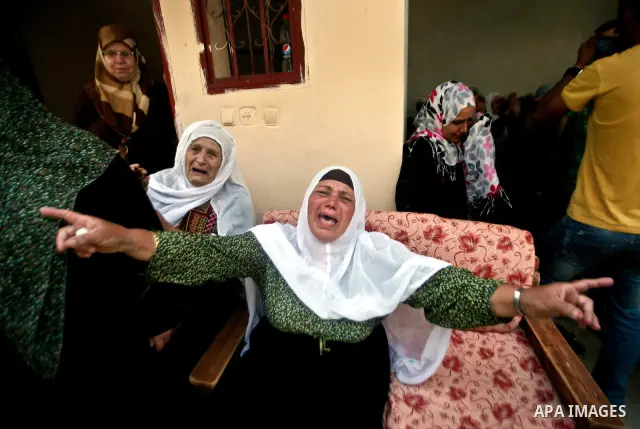 Relatives of Palestinian militant Ismail Odeh mourn during his funeral in Beit Hanun in the northern Gaza Strip on June 18, 2012. Odeh was one of two Palestinians killed in an Israeli strike on north Gaza in the morning,...