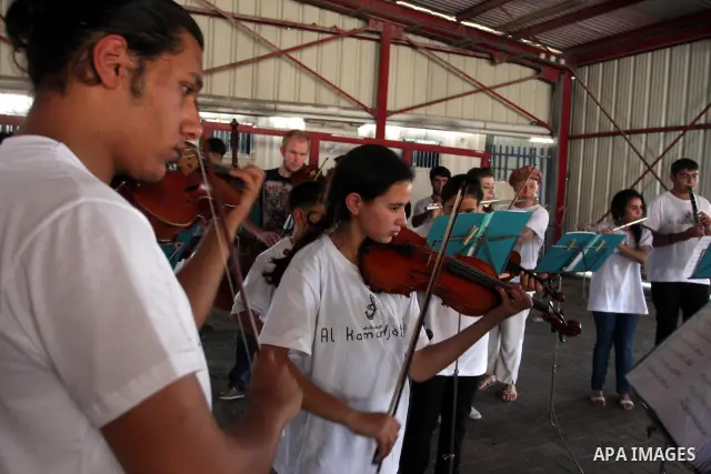 Palestinian, Israeli and foreign musicians band during their presentation at the Israeli military Qalandia checkpoint between Jerusalem city and Ramallah in West Bank on 18 June 2012. Photo by Issam Rimawi