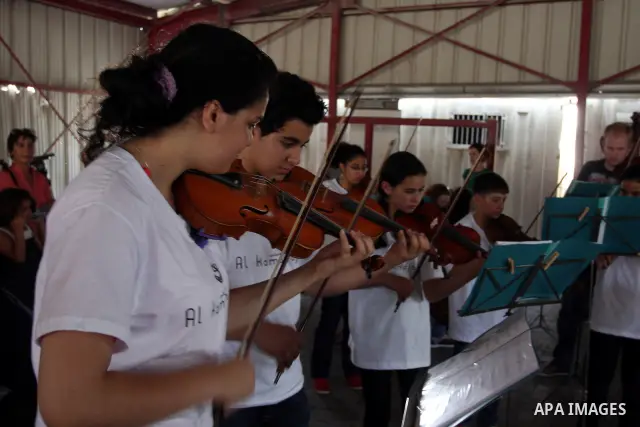 Palestinian, Israeli and foreign musicians band during their presentation at the Israeli military Qalandia checkpoint between Jerusalem city and Ramallah in West Bank on 18 June 2012. Photo by Issam Rimawi