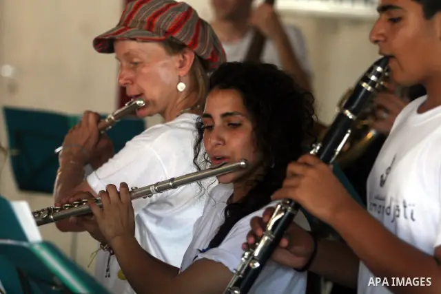 Palestinian, Israeli and foreign musicians band during their presentation at the Israeli military Qalandia checkpoint between Jerusalem city and Ramallah in West Bank on 18 June 2012. Photo by Issam Rimawi