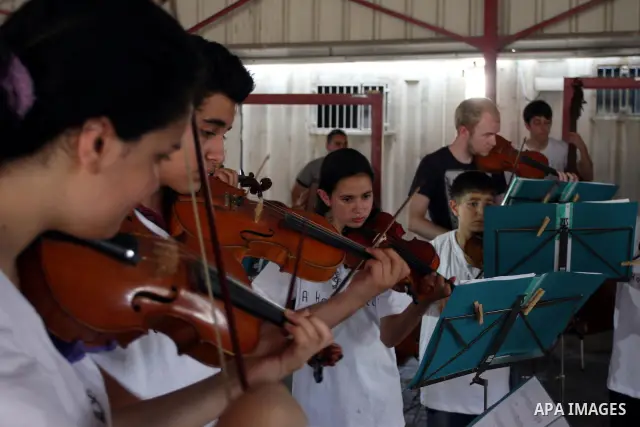 Palestinian, Israeli and foreign musicians band during their presentation at the Israeli military Qalandia checkpoint between Jerusalem city and Ramallah in West Bank on 18 June 2012. Photo by Issam Rimawi