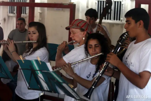 Palestinian, Israeli and foreign musicians band during their presentation at the Israeli military Qalandia checkpoint between Jerusalem city and Ramallah in West Bank on 18 June 2012. Photo by Issam Rimawi